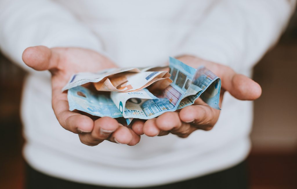 person holding euros