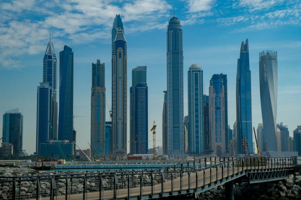 blue concrete city buildings under white and blue cloudy sky