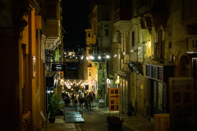 a-street-with-people-and-buildings-on-both-sides
